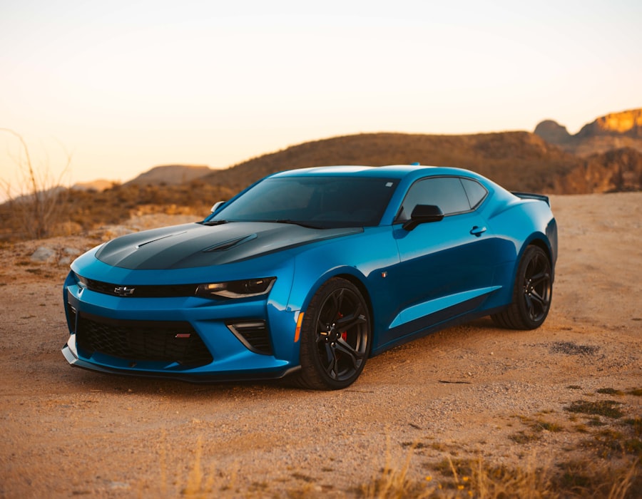 Vibrant blue coupe at sunset on open terrain, evoking a confident next coverage choice